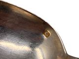 a silver spoon with a metal handle on a white surface