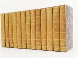 books are lined up in a row on a white surface