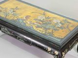 a table with a painting on it that is sitting on a table