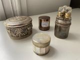 three different types of silver items on a white table