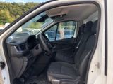 the interior of a white van with the door open and the driver ' s seat down
