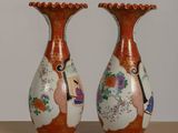 two vases that are sitting on a table