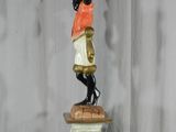 a statue of a woman holding a candelier on top of a pedestal
