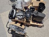 a pile of electronics on the ground next to a pile of boxes