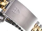 a close up of a watch on a white surface with a silver and gold bracelet