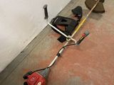 a picture of a lawn mower and a tool on the ground