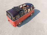 a small red bus with a dog inside of it
