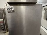 a stainless steel oven sitting in the middle of a kitchen