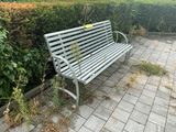a bench that is sitting in the middle of a brick walkway