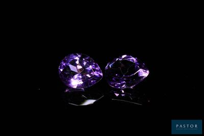 a pair of purple sapphires on a black background
