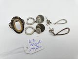 several different rings and earrings on a table with a price tag