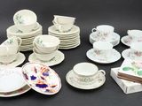 a lot of plates and cups and saucers on the table