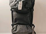 a black backpack with a tag on it sitting on a table