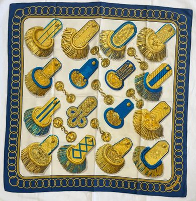 a blue and gold scarf with gold and blue designs on it