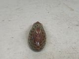 a small rock with a face on it sitting on the floor
