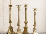 three gold candles are sitting on a marble counter top