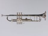 an old silver trumpet is shown against a white background