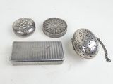 four pieces of silverware including a cigarette case, a cigarette case and a cigarette case