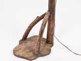 a wooden lamp that is on a stand with a cord