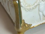 a white and gold tray with a statue on top of it