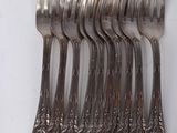 a lot of forks and spoons that are on the table