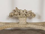 a vase with flowers on top of a wooden bench