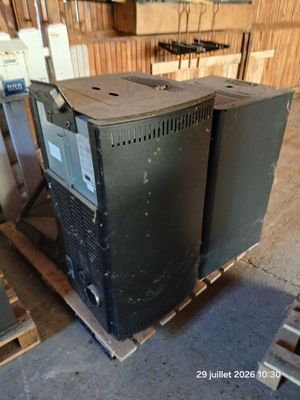 an old tv sitting on top of a pallet in a warehouse