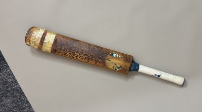 a baseball bat that is laying on top of a table