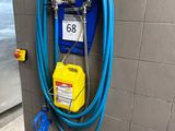 a blue hose attached to a wall in a bathroom