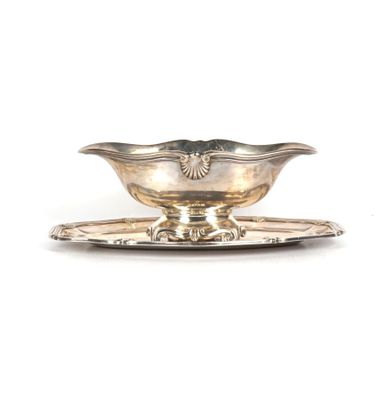 une assiette en argent sur laquelle est posée une soucoupe