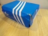 a blue box with white stripes sitting on a wooden table