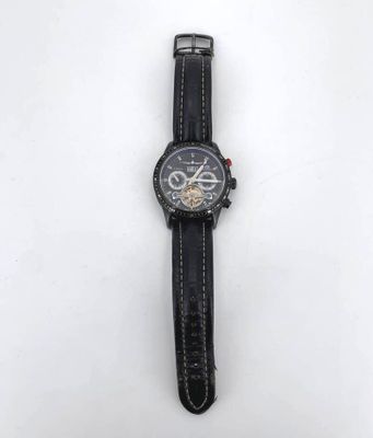 a close up of a wrist watch on a white surface