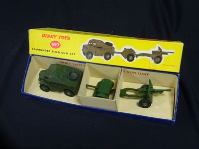 three toy army vehicles in a box on a black surface