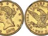a gold coin with an eagle on the front and a woman ' s head on the back