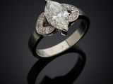 a close up of a diamond ring on a black surface