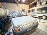 a car that is parked in a garage with other cars