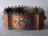 an old metal and wood box with a lion head on it