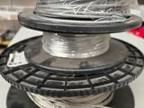 a spool of wire on top of a spool on a table