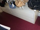 a closet with a lot of purses and handbags hanging on the wall
