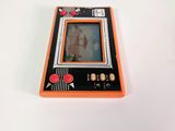 a small orange game console sitting on a white surface
