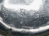 a close up of a silver plate on a table