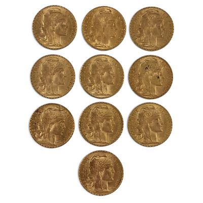 six gold sovereigns of various sizes and shapes on a white surface