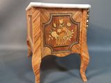 a small wooden table with a marble top on it
