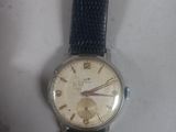 a close up of a watch on a white surface