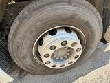 a flat tire on a flatbed truck parked on the side of the road