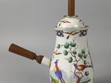 a white tea pot with a wooden handle and a bird design on it