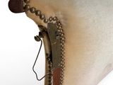 a white pillow that has a brown button on it
