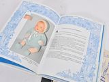 an open book with a picture of a baby doll on it
