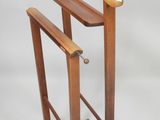a wooden stand with a coat rack on top of it