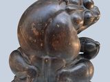 a statue of a frog sitting on top of a table